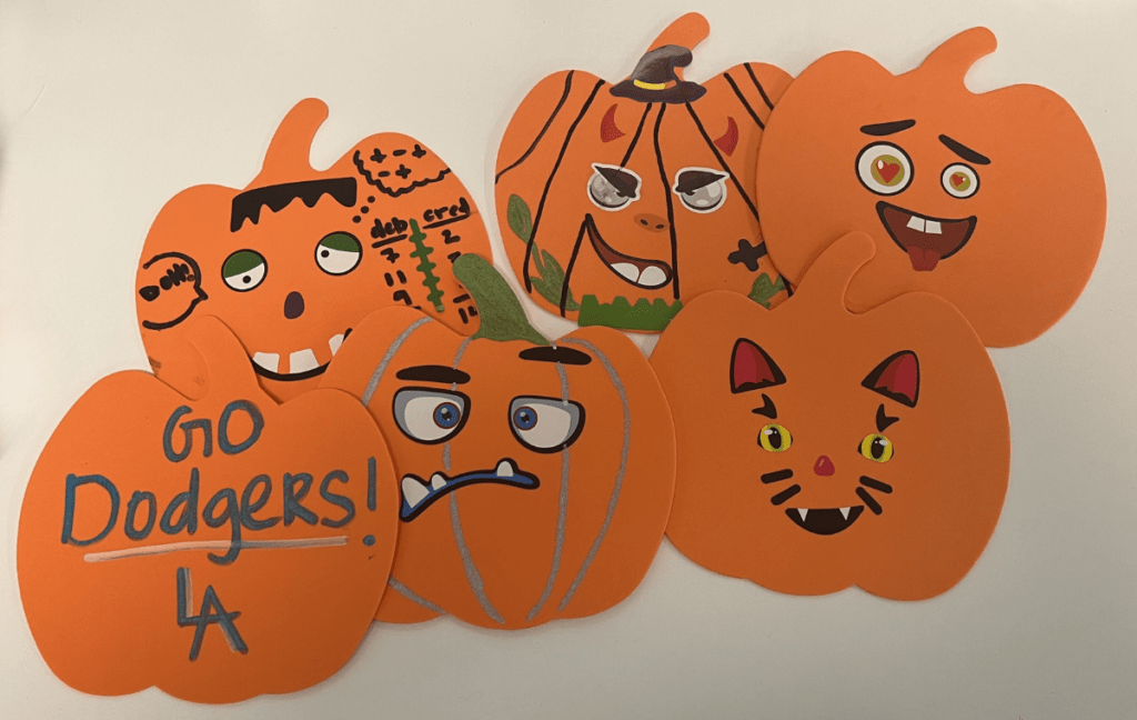 six decorated paper pumpkins