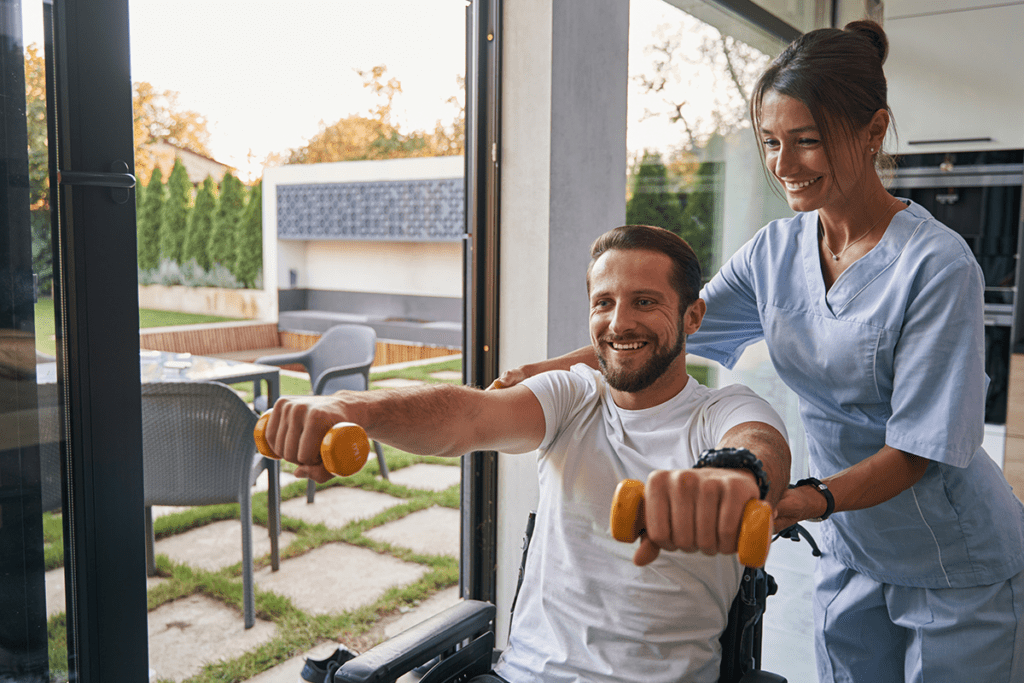 man in wheelchair doing physical therapy with caregiver